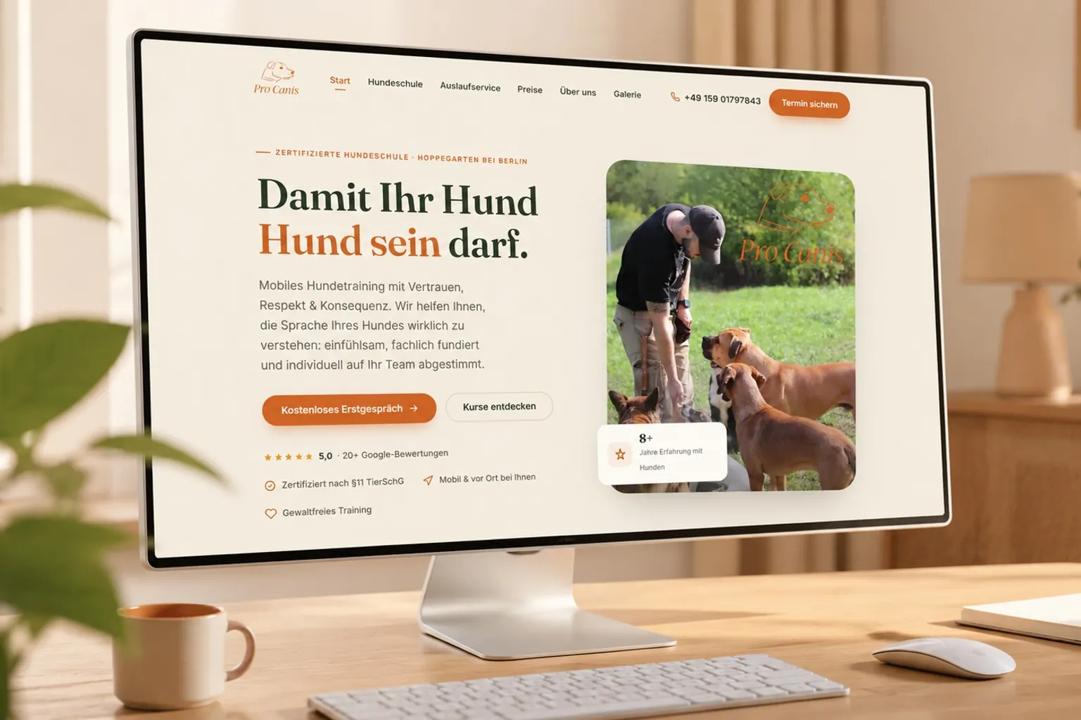 Startseite von Pro Canis Weisbecker auf einem Monitor in einem hellen Arbeitszimmer mit Pflanzen und Morgenlicht.